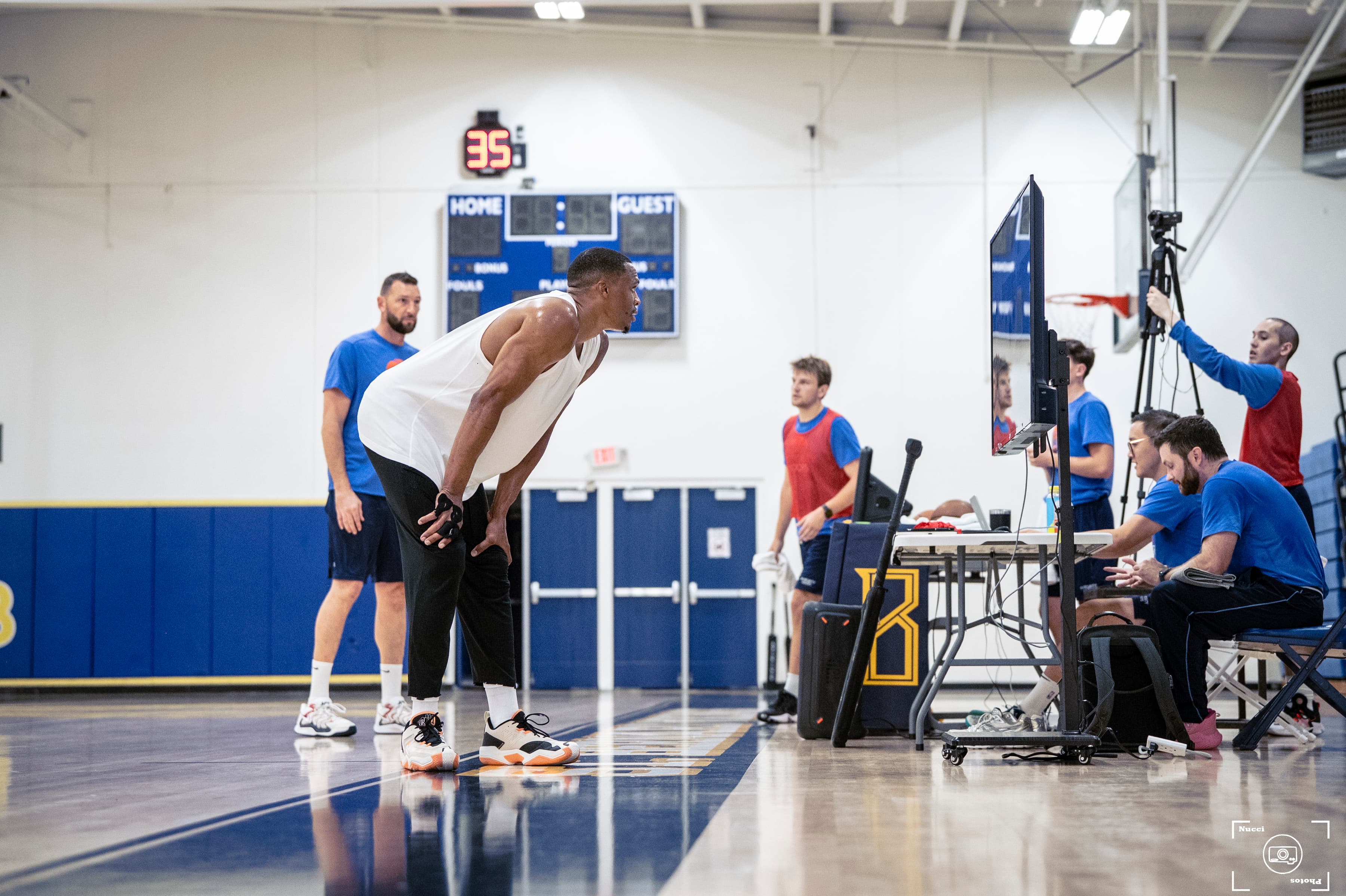 Basketball player resting during a game.